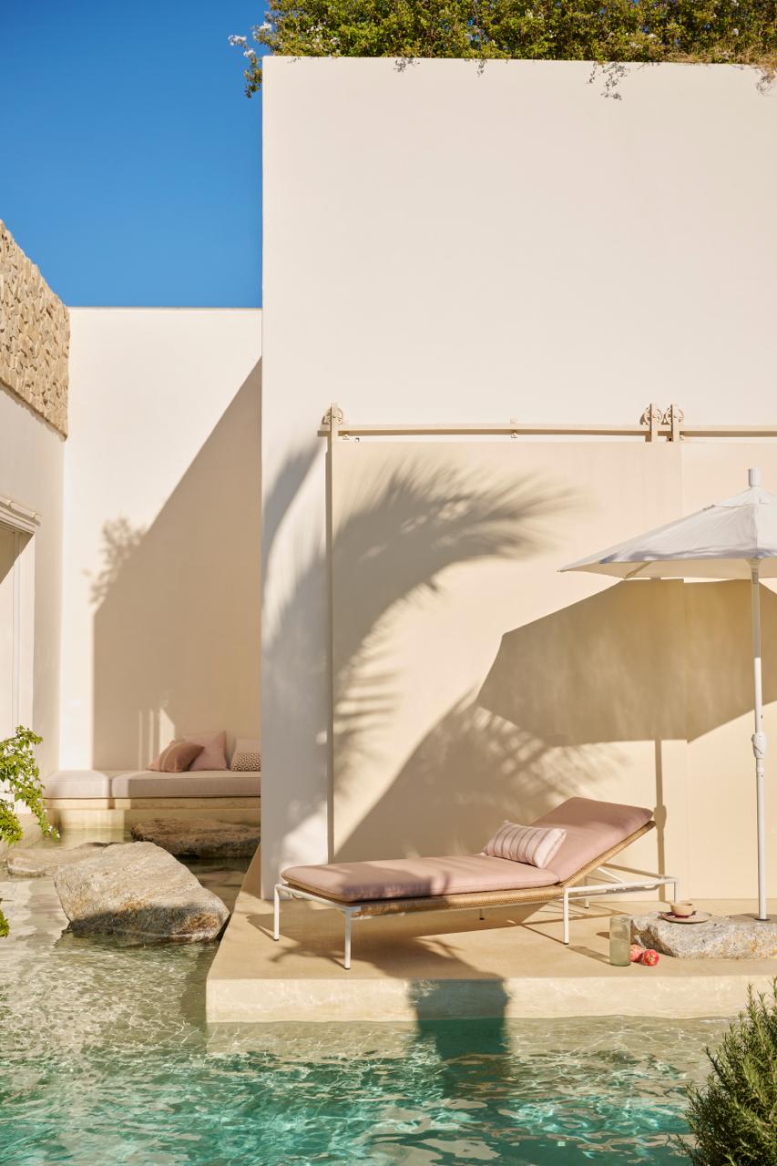 Sunlit white terrace with outdoor drapery and shade