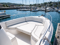 Custom white marine vinyl bow seat cushions and sun pad on a center-console boat