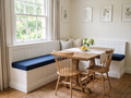 Custom navy Sunbrella bench cushions on a built-in breakfast nook banquette